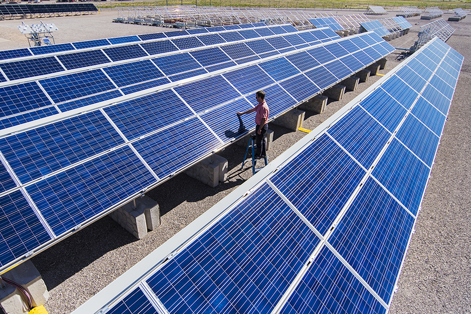 Solar engineer Joshua Stein works on one of several photovoltaic systems being evaluated for industry partners at Sandia National Laboratories in the U.S. Regional Test Centers program. Sandia won a three-year renewal of a Department of Energy contract to manage the RTCs, a network of five sites across the country where industry can assess the performance, reliability and economic viability of solar photovoltaic (PV) technologies. (Photo by Randy Montoya) Solar engineer Joshua Stein works on one of several photovoltaic systems being evaluated for industry partners at Sandia National Laboratories in the U.S. Regional Test Centers program. Sandia won a three-year renewal of a Department of Energy contract to manage the RTCs, a network of five sites across the country where industry can assess the performance, reliability and economic viability of solar photovoltaic (PV) technologies. (Photo by Randy Montoya)
