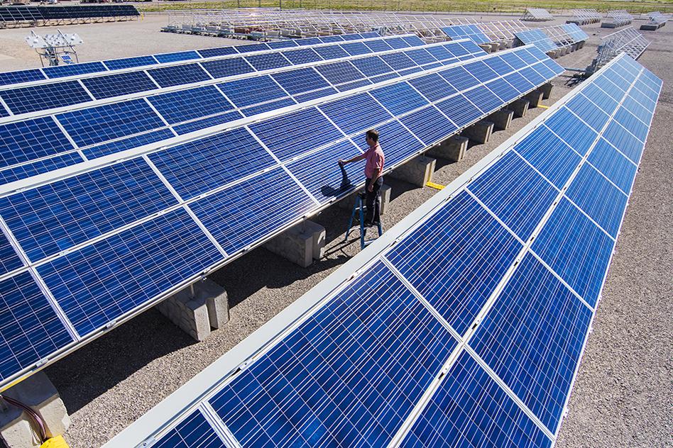 Solar engineer Joshua Stein works on one of several photovoltaic systems being evaluated for industry partners at Sandia National Laboratories in the U.S. Regional Test Centers program. Sandia won a three-year renewal of a Department of Energy contract to manage the RTCs, a network of five sites across the country where industry can assess the performance, reliability and economic viability of solar photovoltaic (PV) technologies. (Photo by Randy Montoya) Solar engineer Joshua Stein works on one of several photovoltaic systems being evaluated for industry partners at Sandia National Laboratories in the U.S. Regional Test Centers program. Sandia won a three-year renewal of a Department of Energy contract to manage the RTCs, a network of five sites across the country where industry can assess the performance, reliability and economic viability of solar photovoltaic (PV) technologies. (Photo by Randy Montoya)